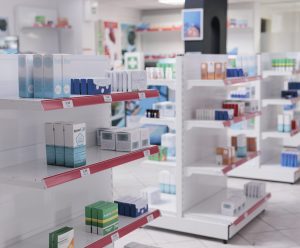 Empty drugstore with bottles and packages full with medicaments, retail shop shelves with pharmaceutical products. Pharmacy space filled with medical drugs and pills, vitamins boxes.